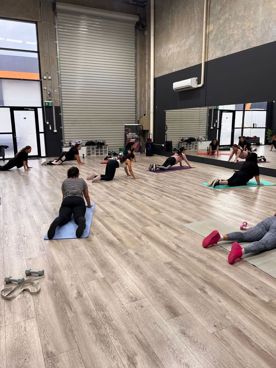 BollyFit members moving through a guided floor exercise in Truganina